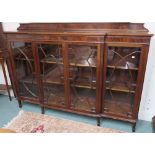 A mahogany breakfront bookcase with four glazed doors on square tapering legs, 130cm high x 183cm
