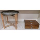 A small metal strong box, 16cm high x 40cm wide x 30cm deep and a brass topped folding table (2)