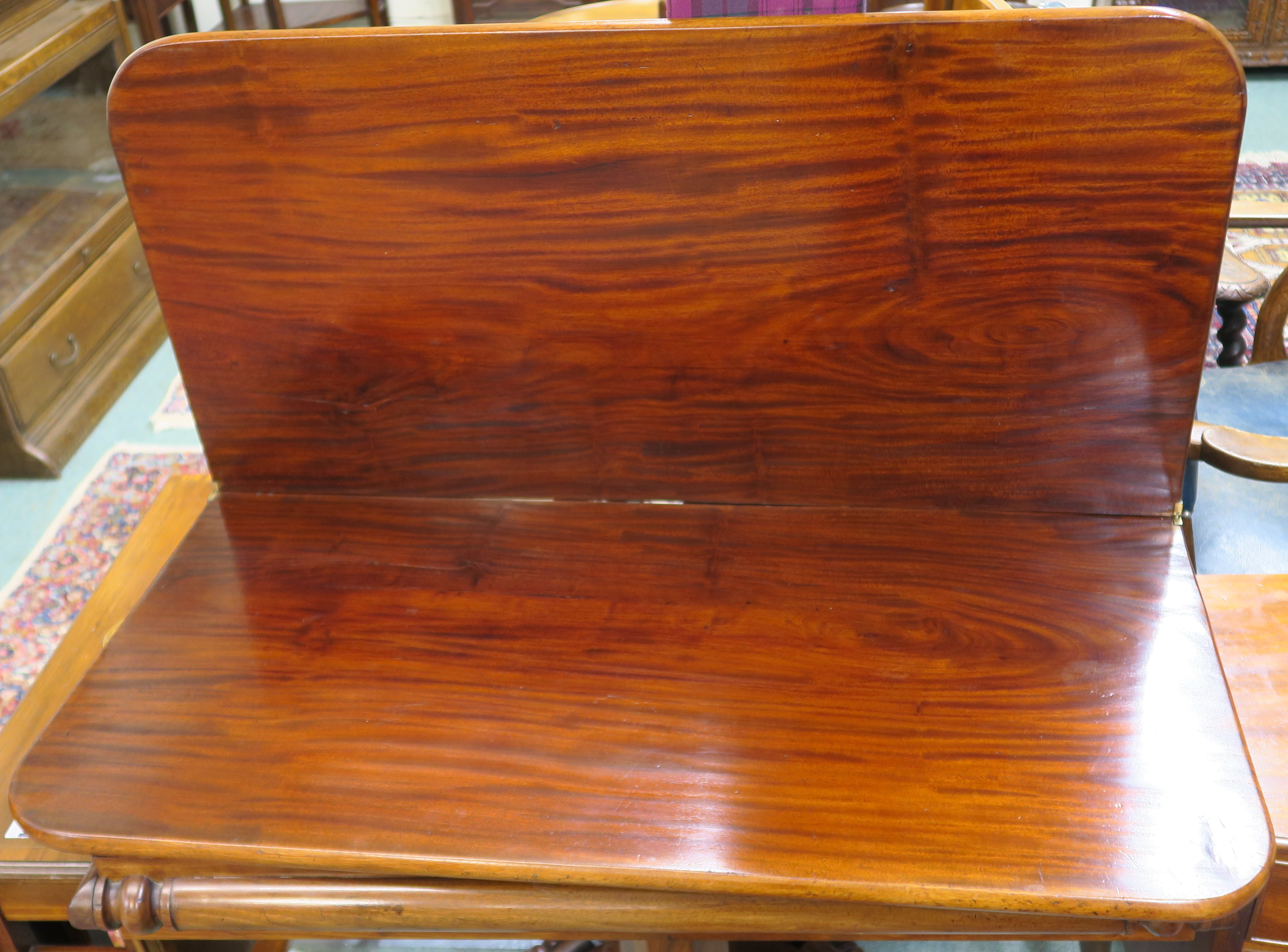 A Victorian mahogany fold over tea table on a pedestal base with four scroll feet, 74cm high x - Image 2 of 3