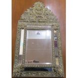 A small brass cushion mirror, 60cm high x 32cm wide Condition Report: Available upon request