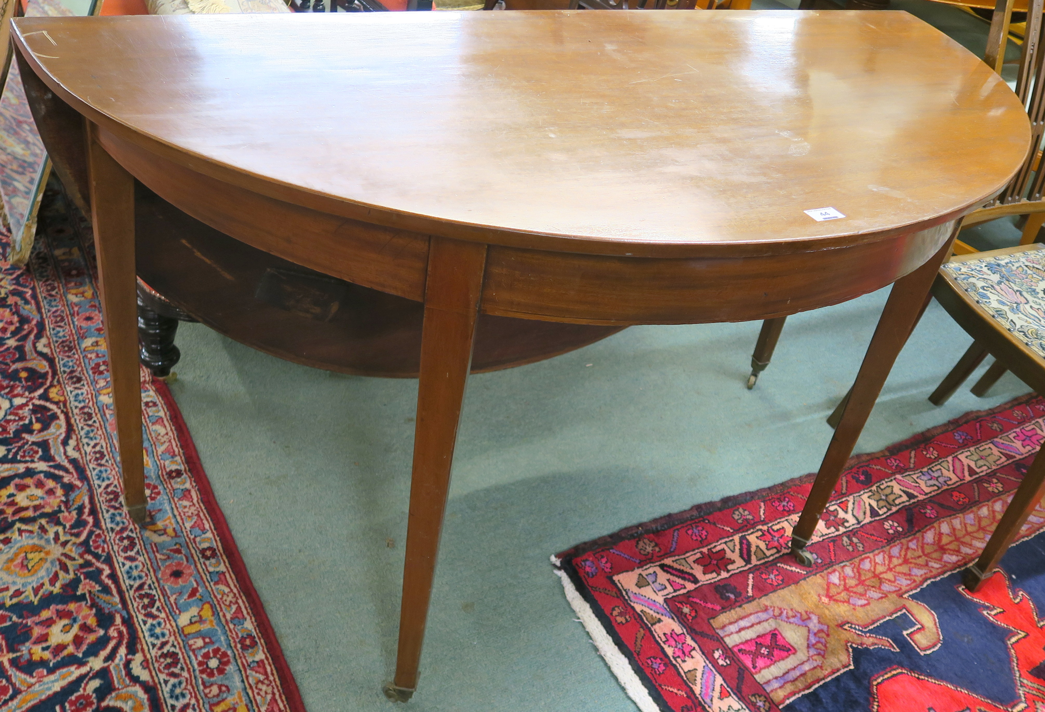 A mahogany demi-lune table with drop flap, 79cm high x 137cm wide x 62cm deep Condition Report: