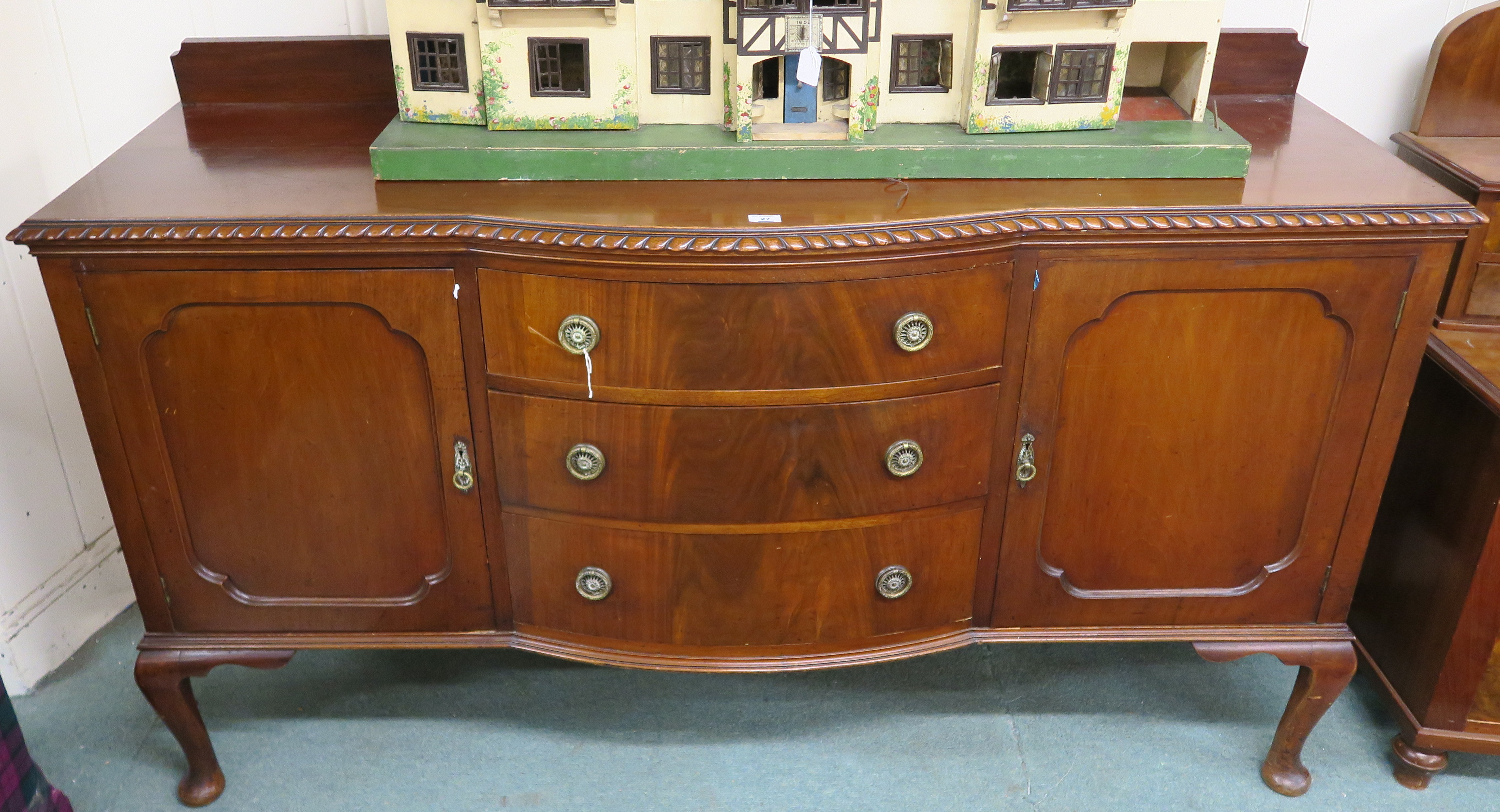 A mahogany sideboard with three drawers flanked by two doors, 119cm high x 182cm wide x 60cm deep