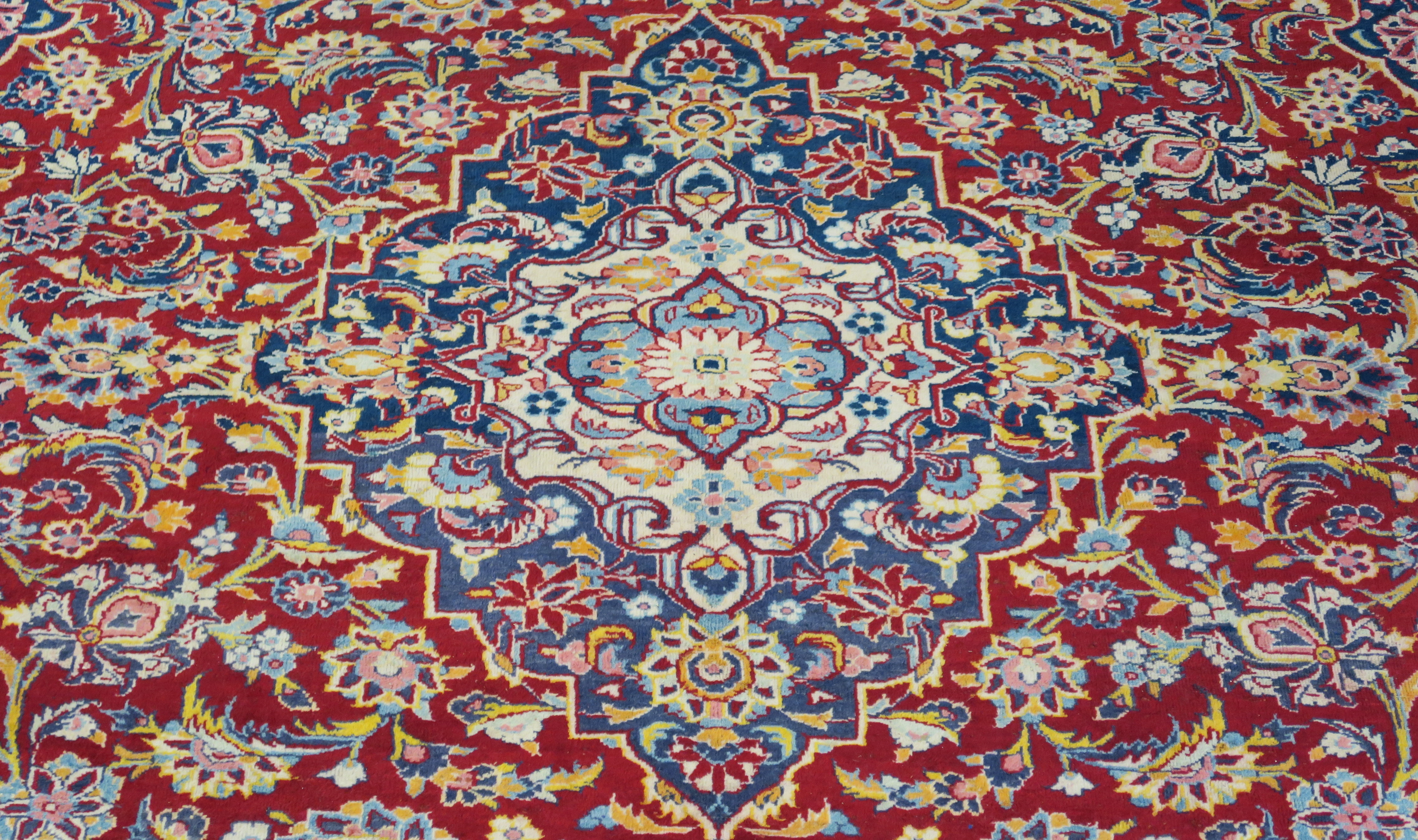 A large red ground Keshan rug with traditional design of blue central medallion, matching - Image 2 of 5