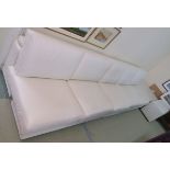 A large cream leather sofa system comprising two sofas, 86cm high x 156cm wide x 100cm deep,