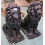 A pair of painted black lightweight resin lions, 62cm high Condition Report: Available upon request