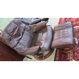 An Ekorness brown leather reclining armchair with matching stool (2) Condition Report: