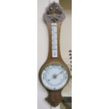 A carved oak barometer/thermometer Condition Report: Available upon request