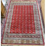 A modern red ground Bokhara rug, 300cm x 200cm Condition Report: Available upon request