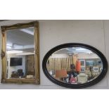 A large oval wall mirror, 70cm x 100cm, a gilt wall mirror, 108cm x 77cm and two other mirrors (4)