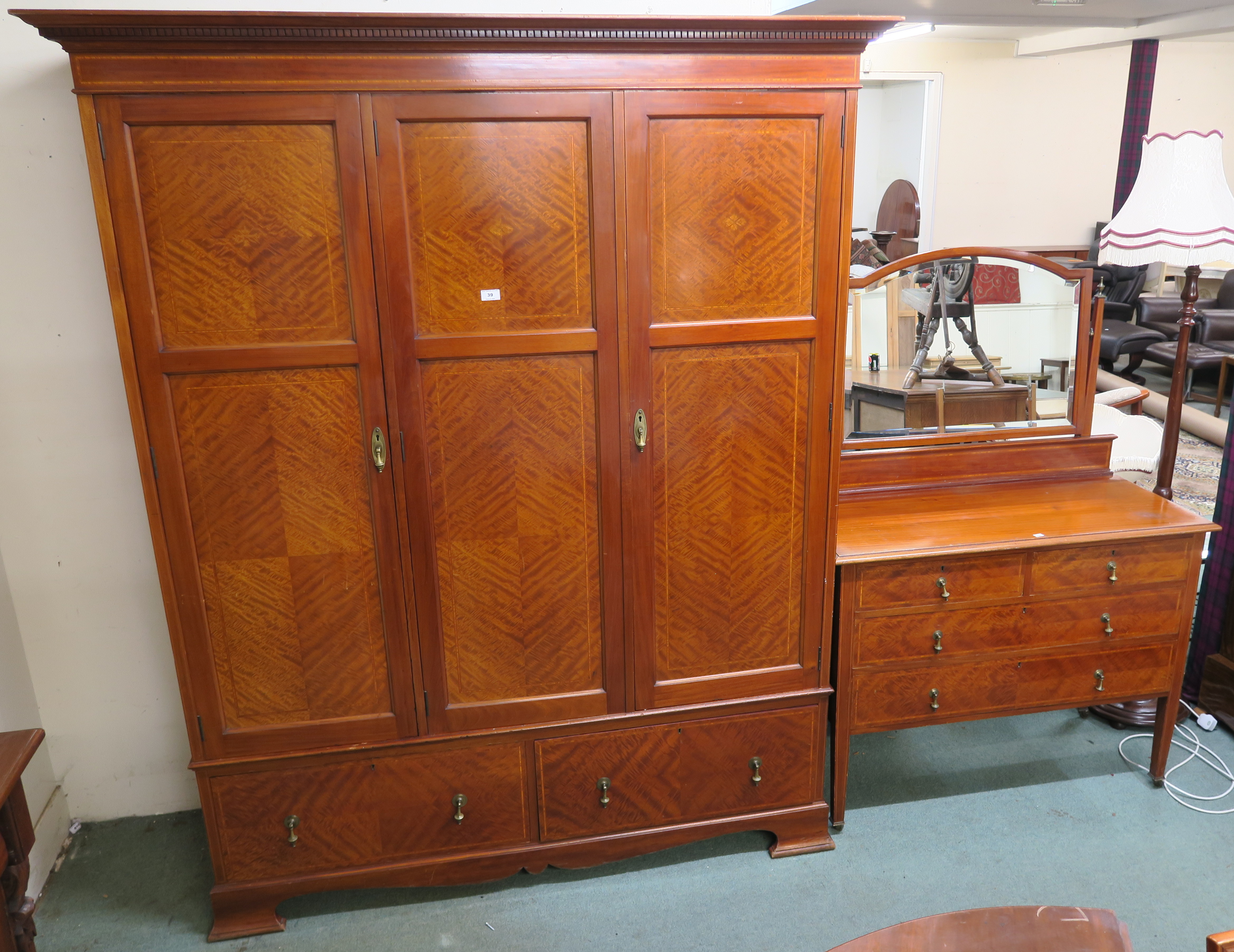 An inlaid mahogany three door fitted wardrobe with two lower drawers on bracket feet, 204cm high x