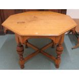 An oak octagonal table with a frieze and cross stretchers, 76cm high x 107cm wide x 107cm deep