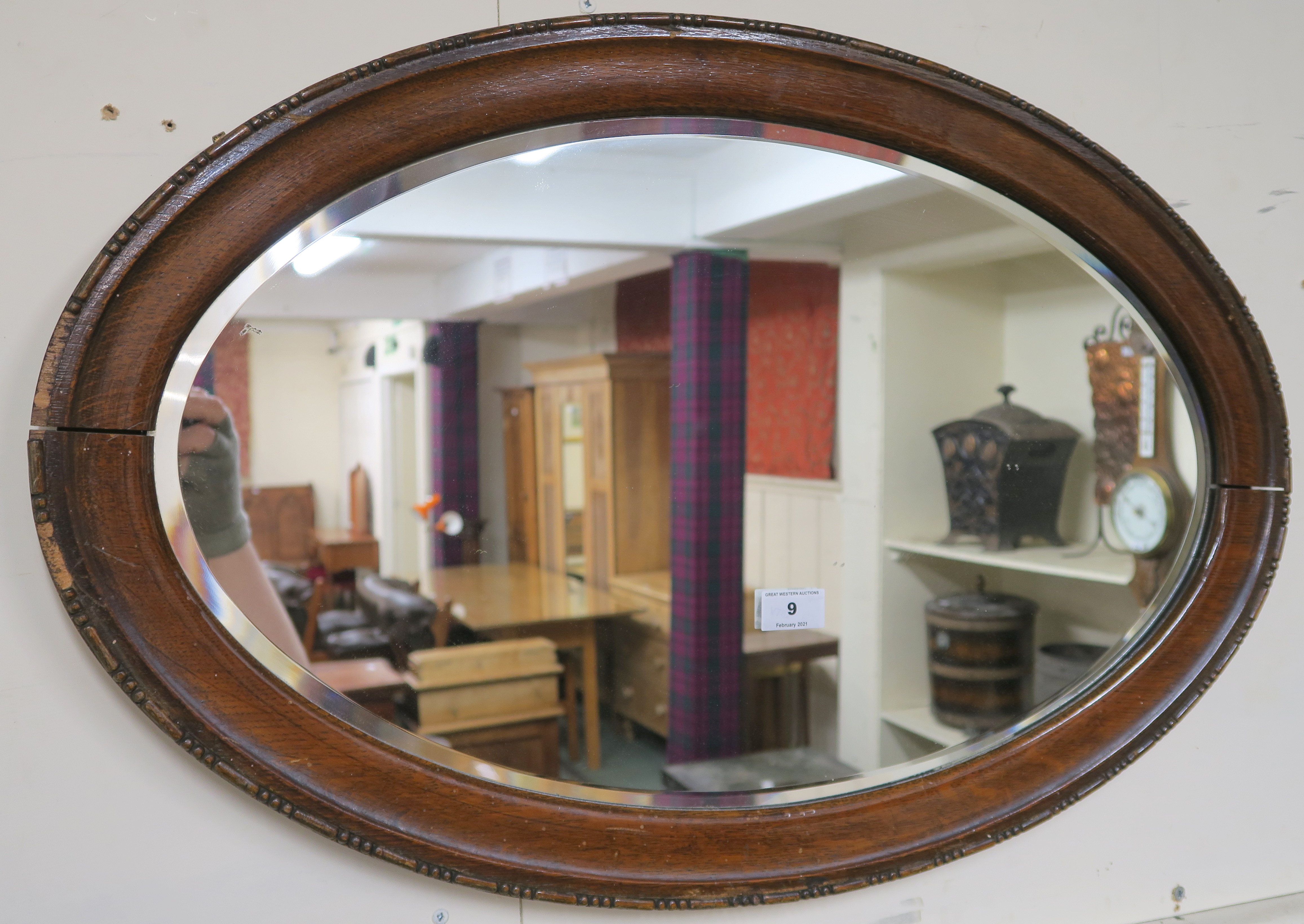 A carved oak circular wall mirror 46cm diameter and an oval wall mirror (2) Condition Report: - Image 2 of 3