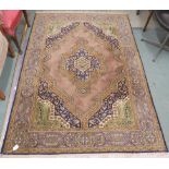 A light brown ground Eastern style rug with central medallion and matching spandrels, 200cm x