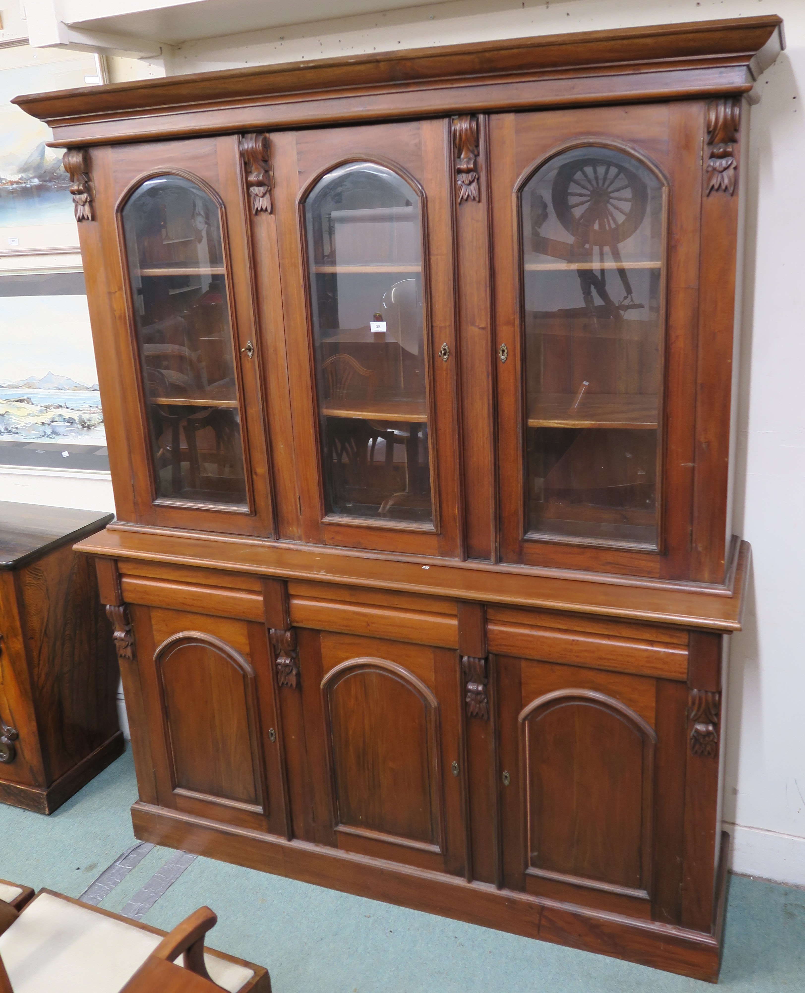 A Reproduction hardwood bookcase with three glazed doors over a base with three drawers over three