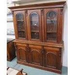 A Reproduction hardwood bookcase with three glazed doors over a base with three drawers over three