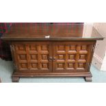 A Younger Toledo oak panelled cabinet with two doors,60cm high x 103cm wide x 40cm deep Condition