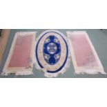 A blue ground Chinese oval rug, 152cm x 91cm and a pair of pink ground Chinese rugs, 137cm x 69cm (