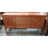 An oak sideboard with three drawers flanked by two doors on stand, 100cm high x 182cm wide x 62cm