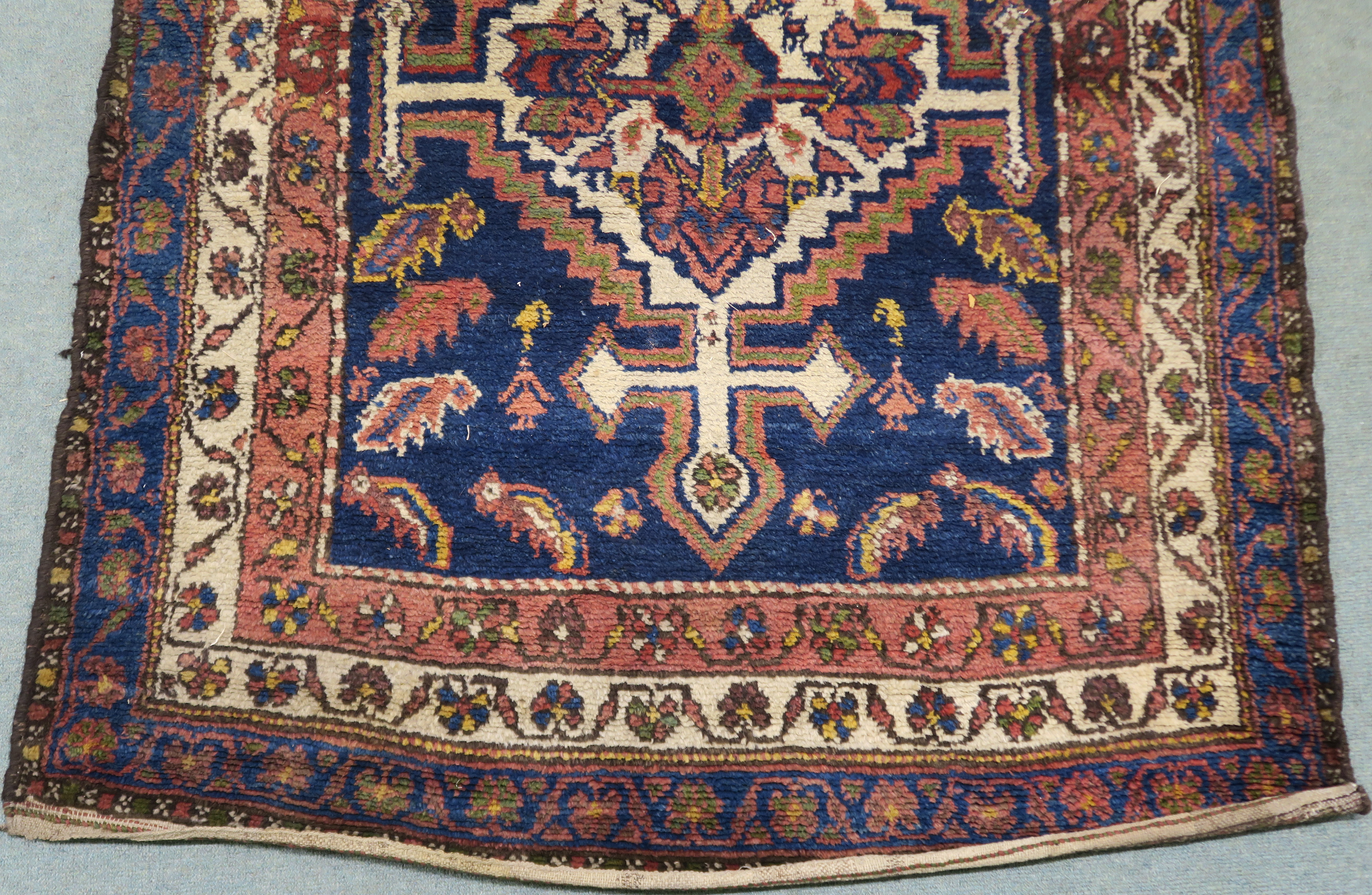 A blue ground Eastern rug with stylised birds and animals with two central medallions, 225cm x 123cm - Image 3 of 4