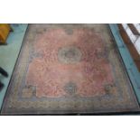 A large pink ground Wilton carpet with central medallion, 400cm x 363cm Condition Report: