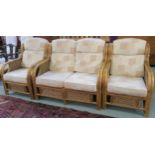 A cane three piece suite with two seater sofa and two chairs with a light fabric upholstery (3)