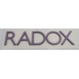 A "RADOX" metal and lilac enamel sign on white board, 34cm high x 112cm wide (letters 23cm high)