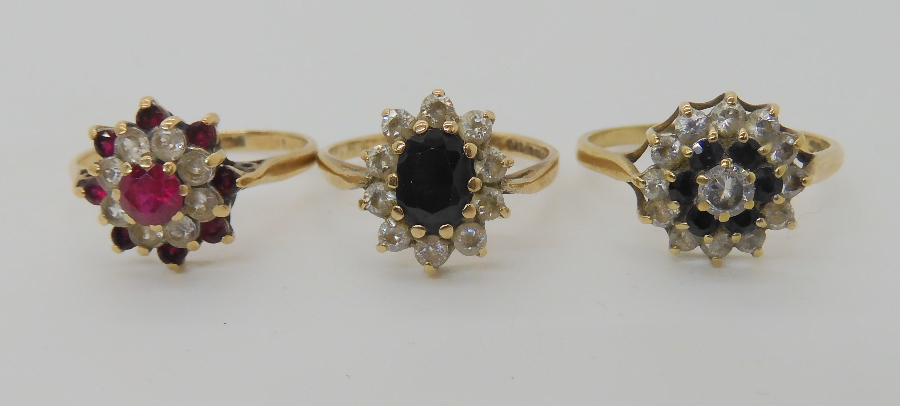 A 9ct gold sapphire and cz flower cluster ring size Q1/2, a further sapphire and cz cluster ring