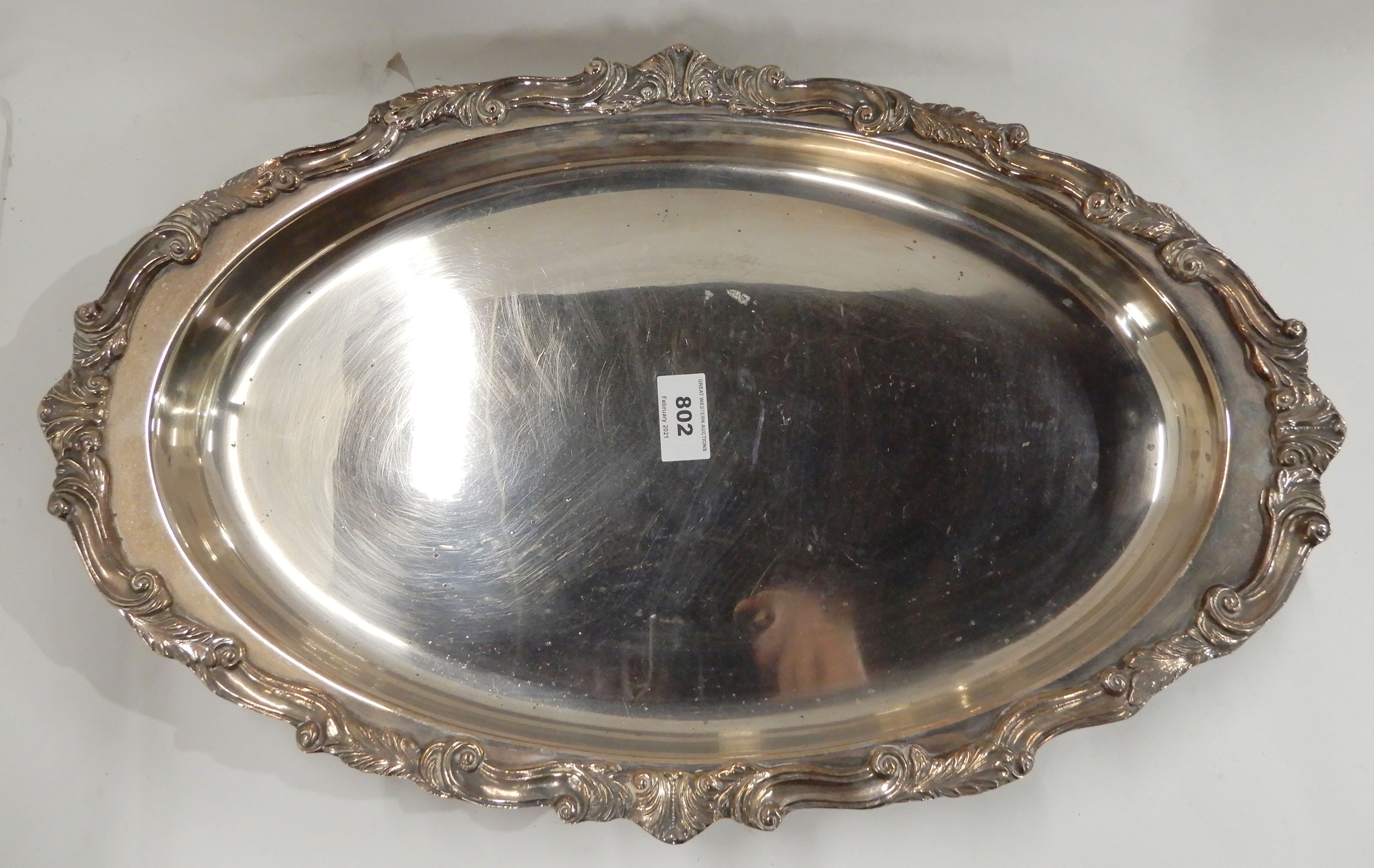 A silver plated serving dish, oval shaped on four scrolling feet, 50cm x 32cm Condition Report: - Image 2 of 3