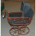 A 20th Century dolls pram, 42cm high Condition Report: Available upon request