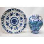 A Delft charger and a Persian two handled jar with enamelled floral glaze Condition Report: