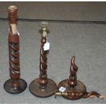 An oak barley twist candle stick, 53m high and another pair of candlesticks, one damaged (3)