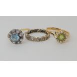 A 9ct gold peridot and pearl set ring size K1/2, a yellow metal clear gem set eternity ring size