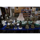 A gilt metal candelabra, two lamp bases, a figural table lamp and a pair of gilt resin candelabra