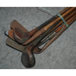 A collection of seventeen hickory-shafted golf clubs including irons and woods Condition Report: