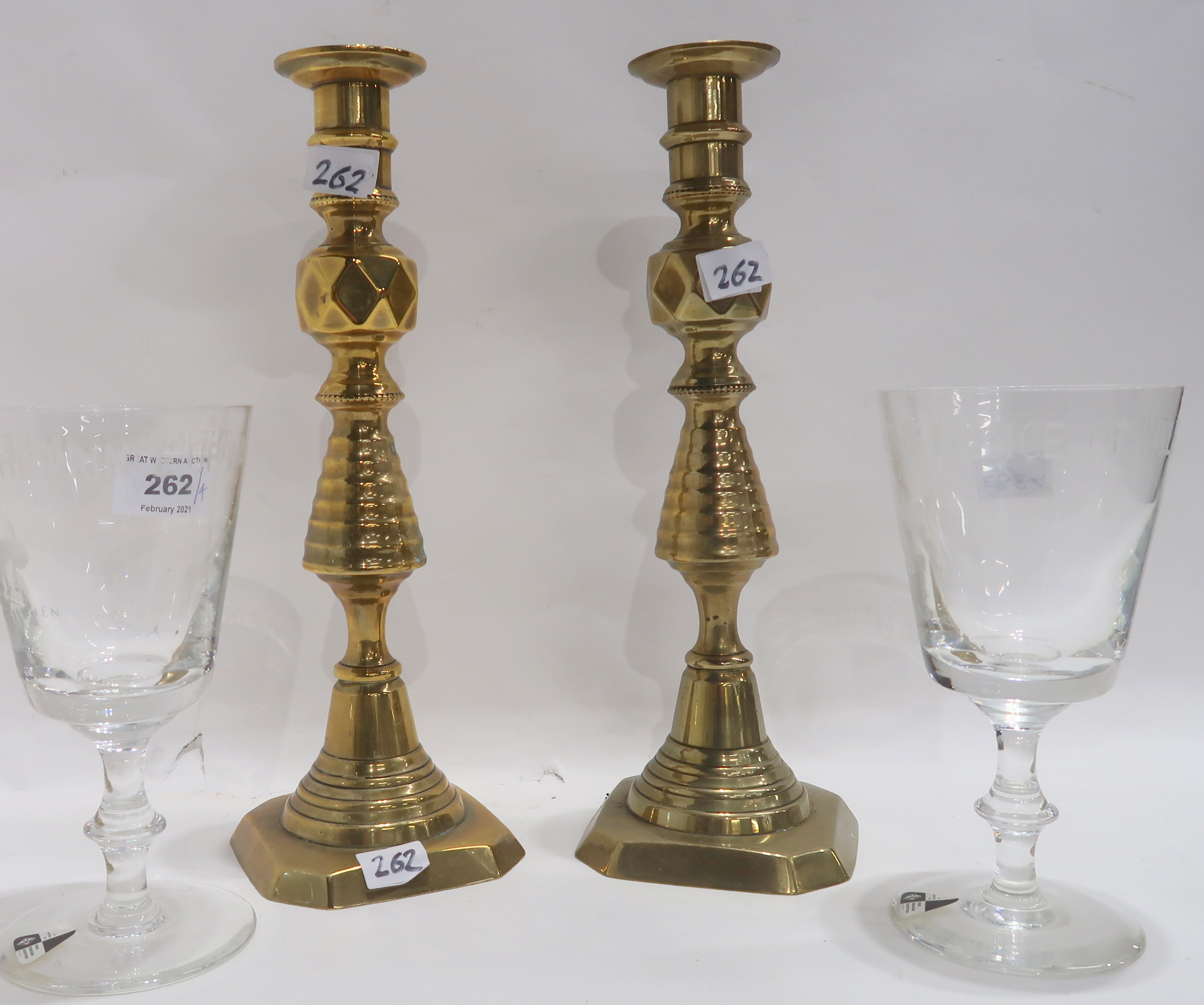 A pair of brass candlesticks and a pair of glass goblet produced for the Design Centre to