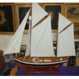 A large model boat on stand, 87cm wide x 105cm high and two other model boats (3) Condition