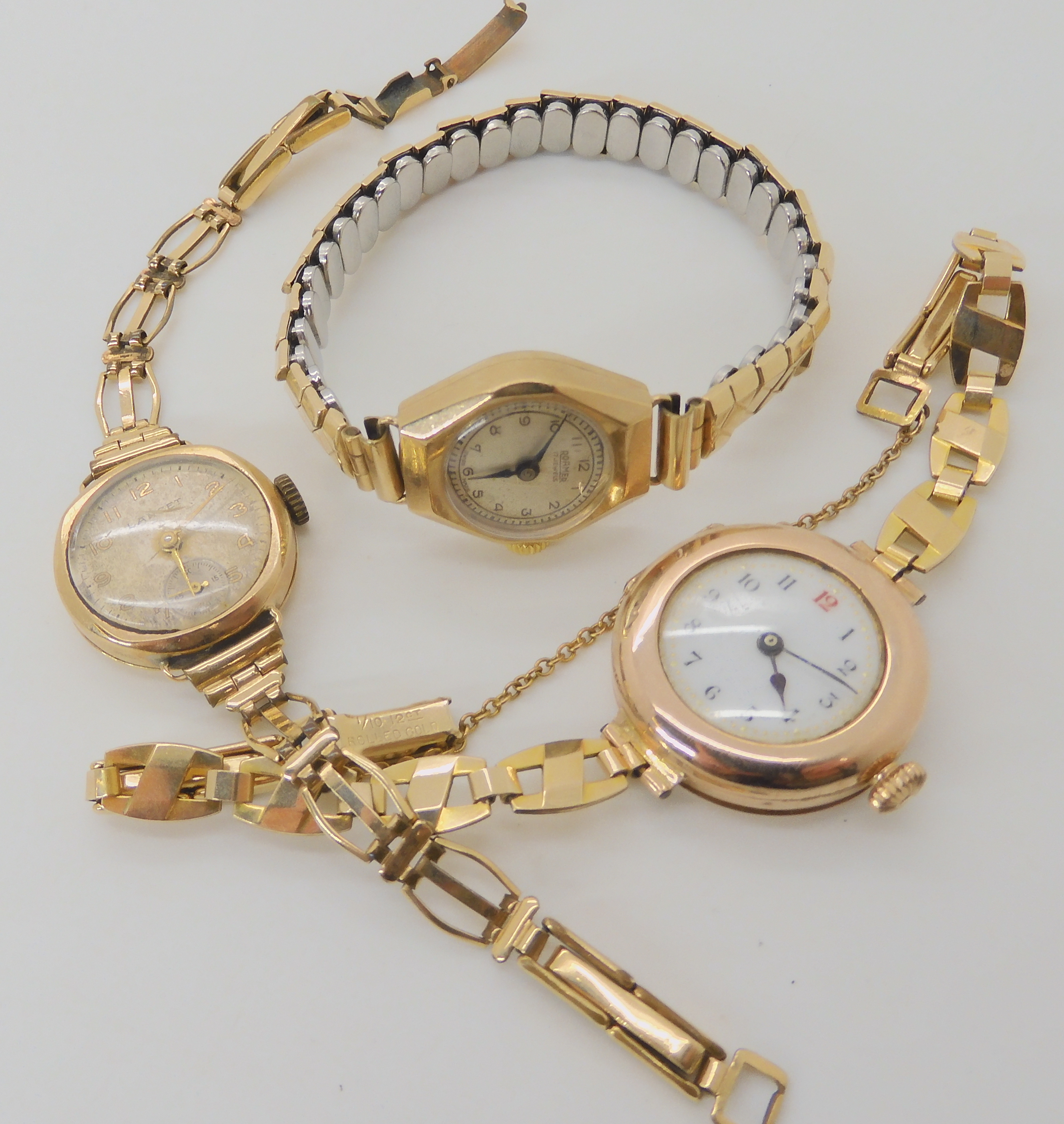 Three 9ct gold cased ladies watches all three with rolled gold or gold plated straps, weight