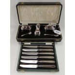 A lot comprising a cased three piece EP condiment set and a cased set of six silver handled butter