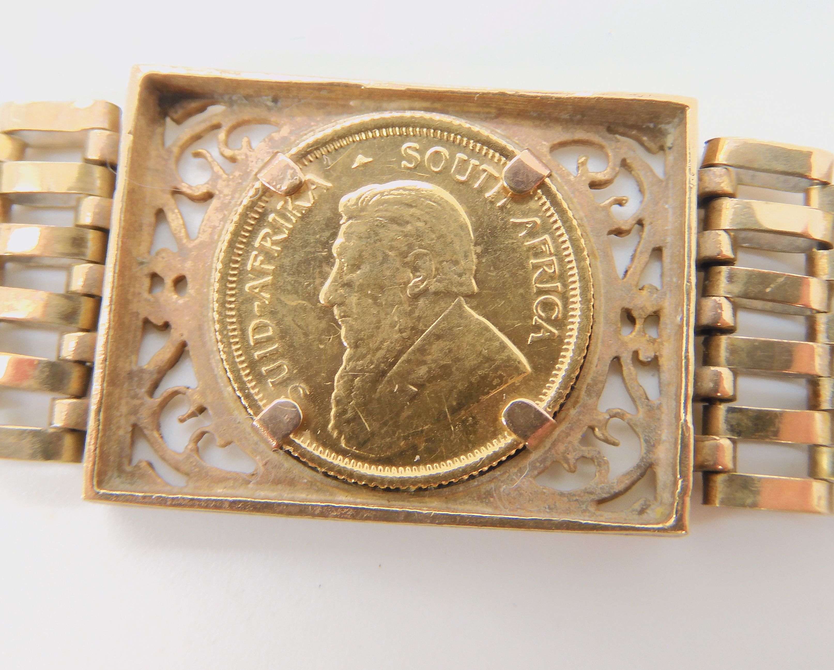 A 9ct gold gate bracelet set with a 1980 1/10th Krugerrand coin, weight combined 13.8gms there is no - Image 2 of 3