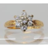 A 9ct gold diamond flower ring set with estimated approx 0.20cts of brilliant cut diamonds, finger