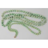 Two strings of Chinese green hardstone beads, length 48cm and 86cm Condition Report: Not available