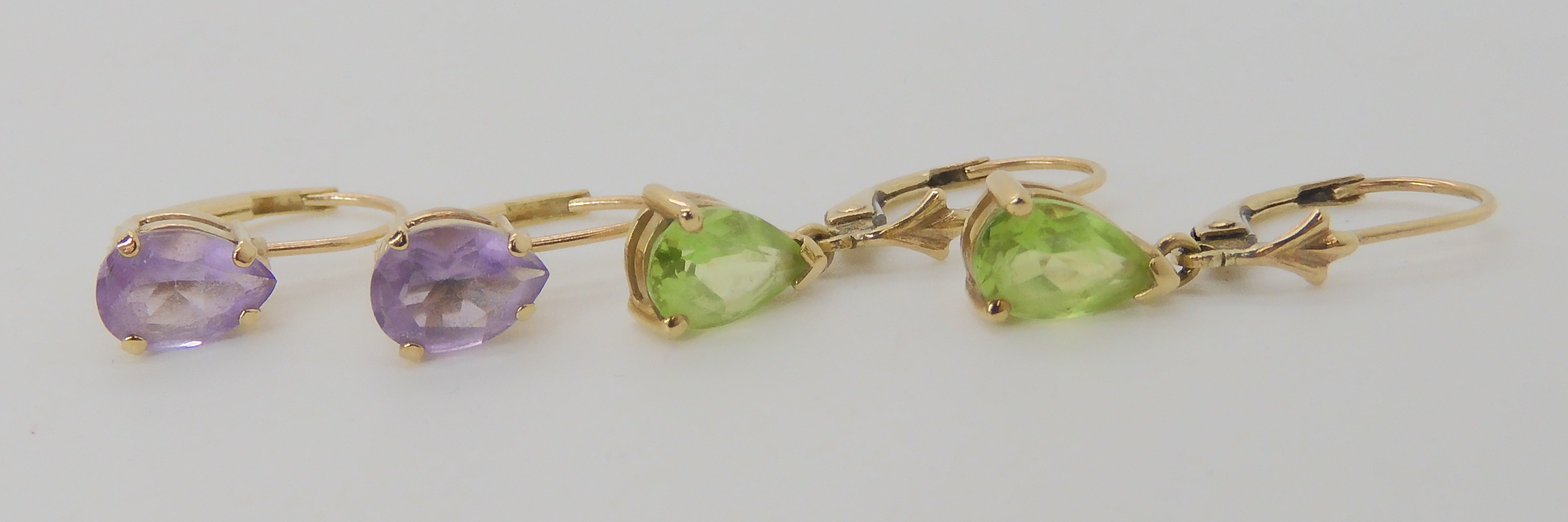 A pair of 9ct gold peridot earrings together with a pair of amethyst earrings, weight combined 2. - Image 2 of 3