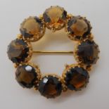 A bright yellow metal citrine set rondel brooch, diameter 4cm approx, weight 12.6gms Condition
