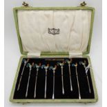 A cased set of nine sterling silver cocktail forks, the enamelled finials modelled as cockerels,