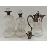 A lot comprising two silver topped decanters, Birmingham 1895, a silver decanter top and an EP