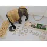 A German powder compact, a collection of silver and costume jewellery and a stuffed elephant