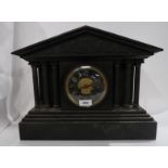A black slate mantle clock, the column front and sides below a classical fighting frieze, the French