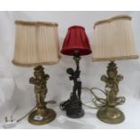 A pair of cherub table lamps and another single lamp Condition Report: