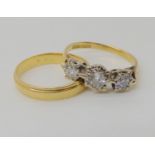 An 18ct gold three stone diamond ring set with estimated approx 0.25cts of brilliant cut diamonds,
