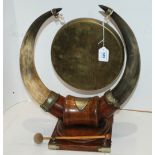 An animal horn table gong on oak stepped base, 47cm high Condition Report: Available upon request